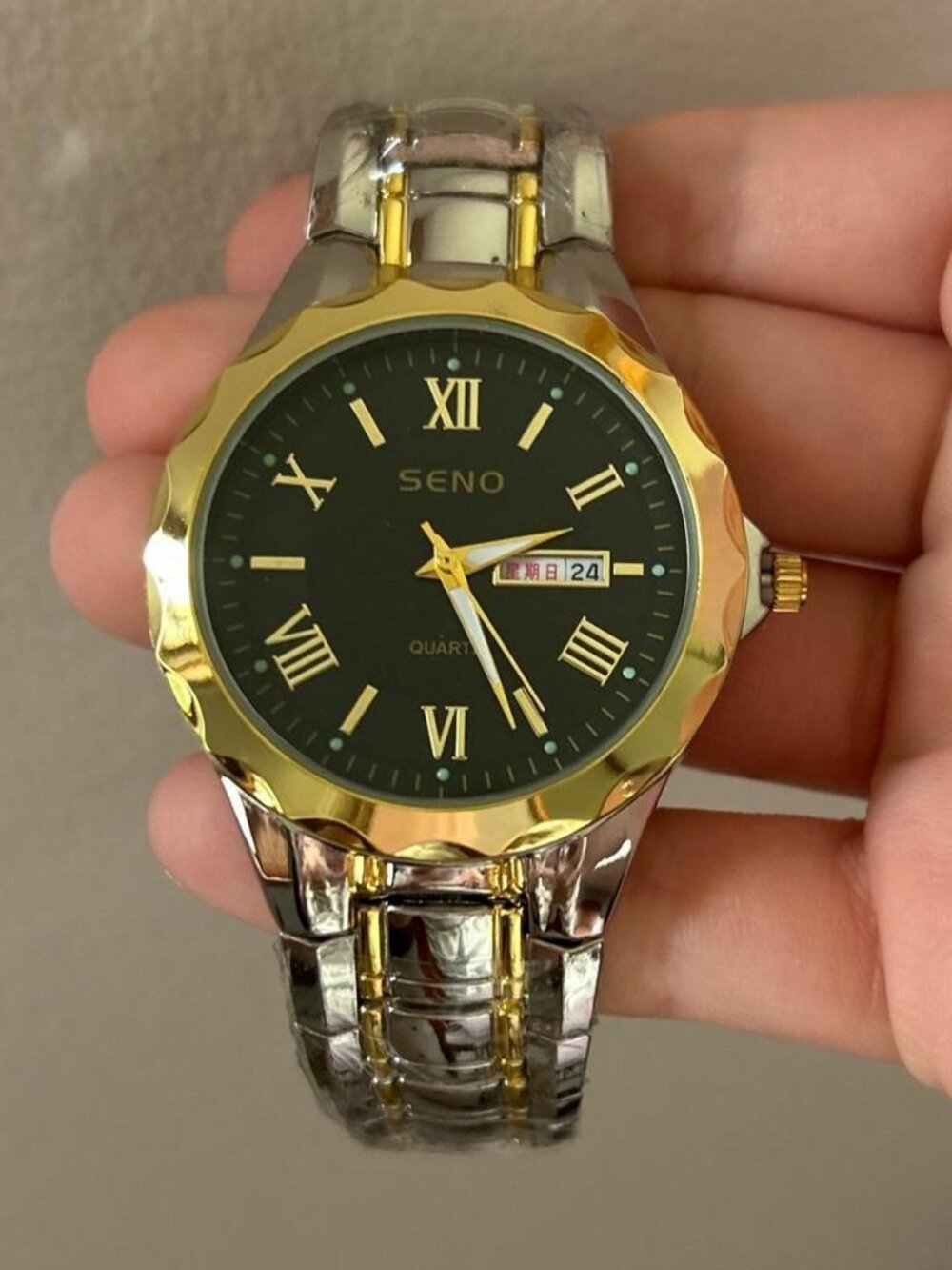 Black and gold analogue watch